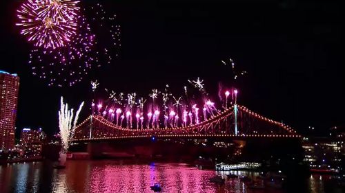 Fireworks are set off from the Story Bridge, city rooftops, and barges. (9NEWS)