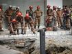 Fire and Rescue department checking on after receiving reports that a woman has fallen into the sinkhole after a section of the sidewalk caved in Kuala Lumpur, Friday, Aug. 23, 2024. 