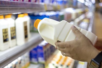 purchasing milk at the supermarket