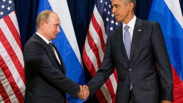 Russian President Vladimir Putin shakes hands with US President Barack Obama.