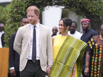 Prince Harry, left, and Meghan, right, holding hands upon arrival at the government house in Lagos Nigeria, Sunday, May 12, 2024. Prince Harry and his wife Meghan are in Nigeria to champion the Invictus Games, which Prince Harry founded to aid the rehabilitation of wounded and sick servicemembers and veterans. 