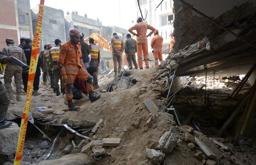Rescue workers conduct an operation to clear the rubble and search for bodies at the site of Monday's suicide bombing.