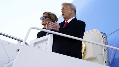 President Donald Trump and first lady Melania Trump board Air Force One at Andrews Air Force Base, Md., Wednesday, Jan. 20, 2021