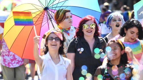 Attendees of the Midsumma Pride March are seen along Fitzroy street in St Kilda, Melbourne today.