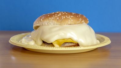 delicious cheeseburger overflowing with extra mayonnaise.