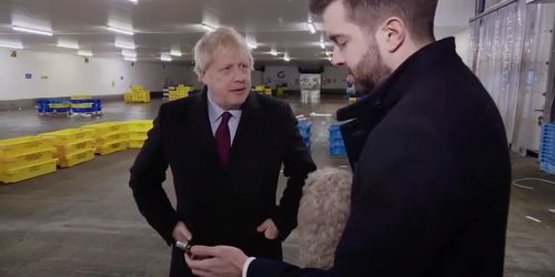 UK Prime minister Boris Johnson refuses to look at the photograph on Joe Pike's phone before taking it off the ITV reporter and putting it in his pocket