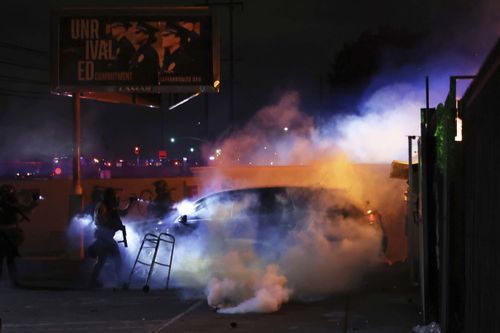 Law enforcement analyse a car pinch a personification wrong during a protestation successful Compton.