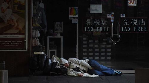 A man sleeps on George street in Sydney's CBD.