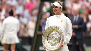 Marketa Vondrousova smiles with Wimbledon&#x27;s women&#x27;s singles trophy following her victory over Ons Jabeur in the final.
