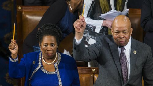 Democratic Congresswoman from Texas Sheila Jackson lee and Democratic Congressman from Georgia John Lewis waved pencils when President Barack Obama mentioned free speech. (AAP)