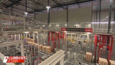 Stretching 35 metres high, the enormous Coles warehouse is laden with supermarket essentials.