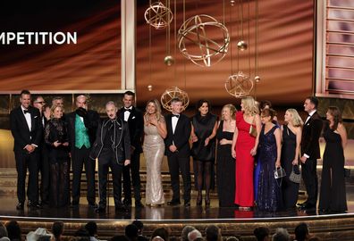 LOS ANGELES, CALIFORNIA - SEPTEMBER 14: Alan Cumming (6th L, holding trophy) and cast and crew of  "The Traitors" accept the Outstanding Reality Competition Program award onstage during the 77th Primetime Emmy Awards at Peacock Theater on September 14, 2025 in Los Angeles, California.  (Photo by Kevin Winter/Getty Images)