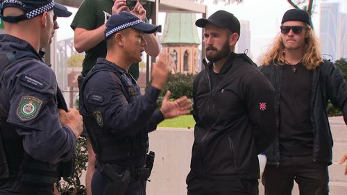 Police speak to a man in North Sydney.