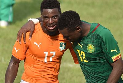 Ivory Coast's Serge Aurier embraces Henri Bedimo after the draw.