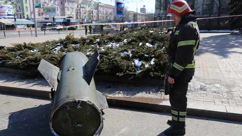 A firefighter looks at a fragment of a Ukrainian Tochka-U missile on a street in Donetsk in eastern Ukraine, Monday, March 14, 2022. 