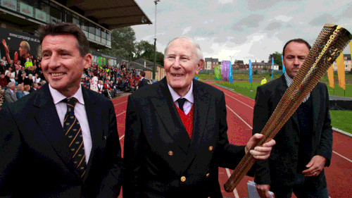 Sir Roger Bannister passed the Olympic flame to a torchbearer on July 10, 2012. (AAP)