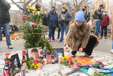 A person places a memorial candle for John Lennon on the 40th anniversary of his death at Strawberry Fields in Central Park on December 08, 2020 in New York City. 