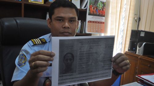 A Bali immigration official shows the passport page and ID card of Febri Andri Ansyah, now known as Mayang Prasetyo. (AAP)
