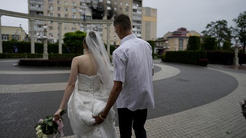 Yevhen Levchenko and Nadiia Prytula leave after getting married in Irpin, on the outskirts of Kyiv.