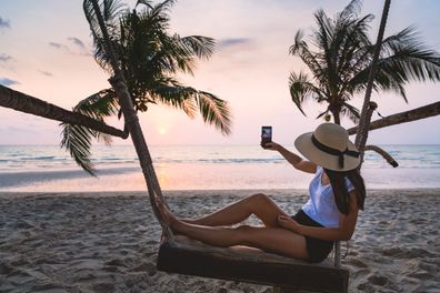 Influencer taking photo of a beach in Thailand