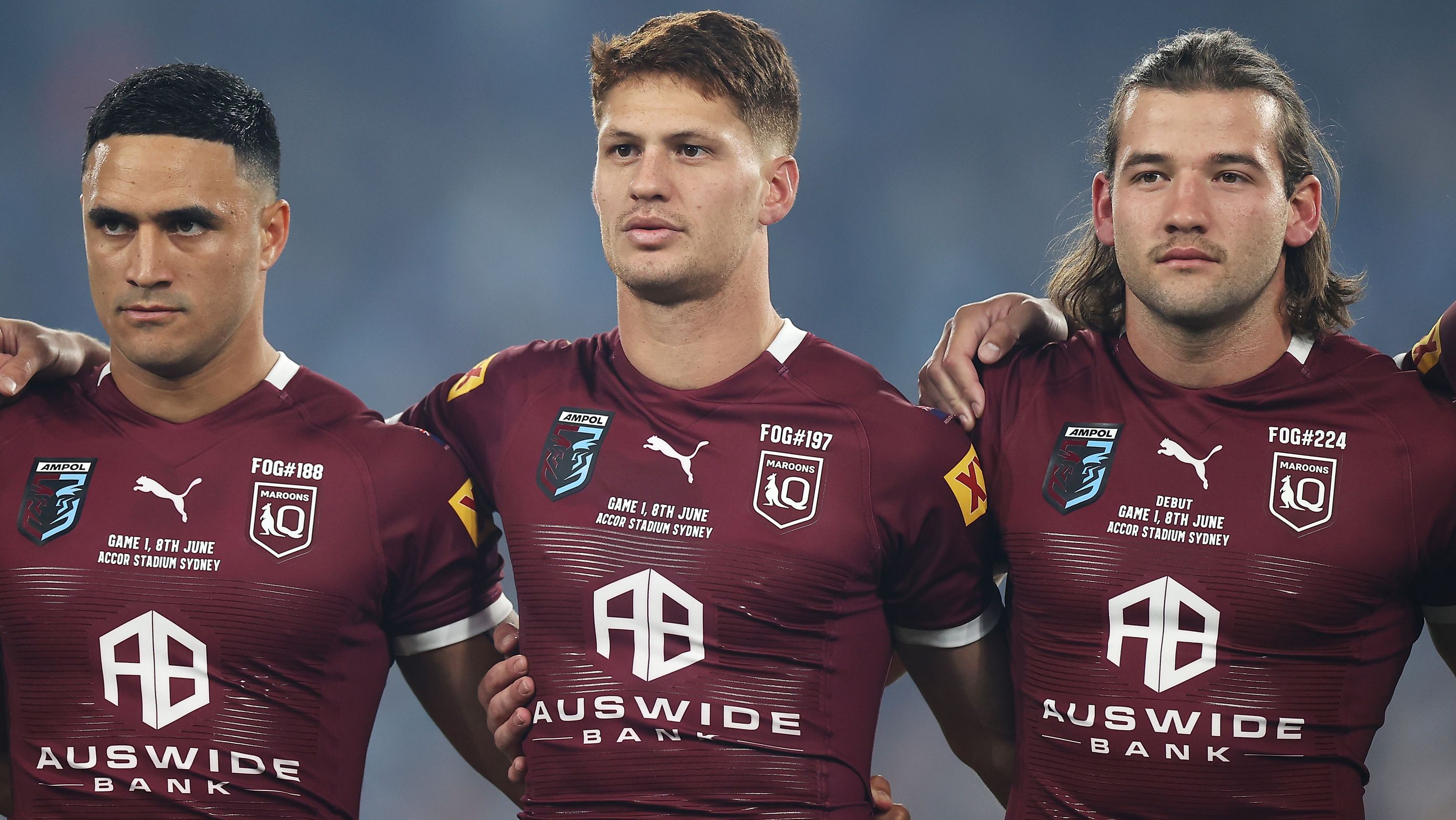 SYDNEY, AUSTRALIA - JUNE 08: (L-R) Valentine Holmes, Kalyn Ponga and Patrick Carrigan of the Maroons line up for the national anthem before game one of the 2022 State of Origin series between the New South Wales Blues and the Queensland Maroons at Accor Stadium on June 08, 2022, in Sydney, Australia. (Photo by Mark Kolbe/Getty Images)