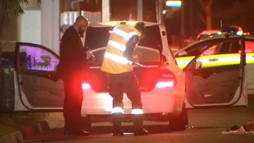 Adelaide police investigate the car where a woman was found dead next to an injured man.