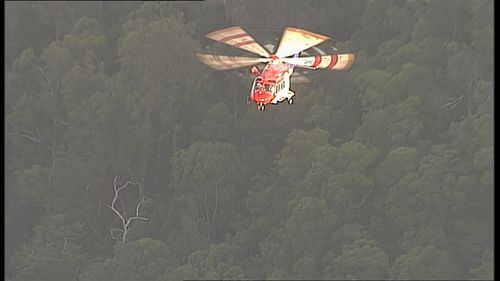 A search and rescue helicopter hovers above the man. Picture: 9NEWS