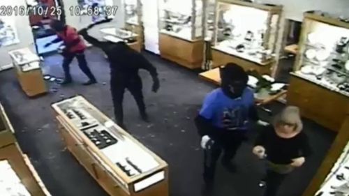 One offender is shown wielding a what appears to be a hammer. (9NEWS)