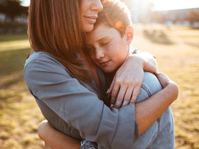 Woman embracing teenage son