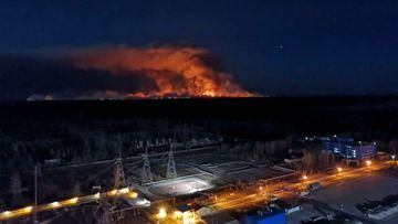 In this photo taken from the roof of Ukraine&#x27;s Chernobyl nuclear power plant late Friday April 10, 2020, a forest fire is seen burning near the plant inside the exclusion zone.  Ukrainian firefighters are labouring to put out two forest blazes in the area around the Chernobyl nuclear power station that was evacuated because of radioactive contamination after the 1986 explosion at the plant. 