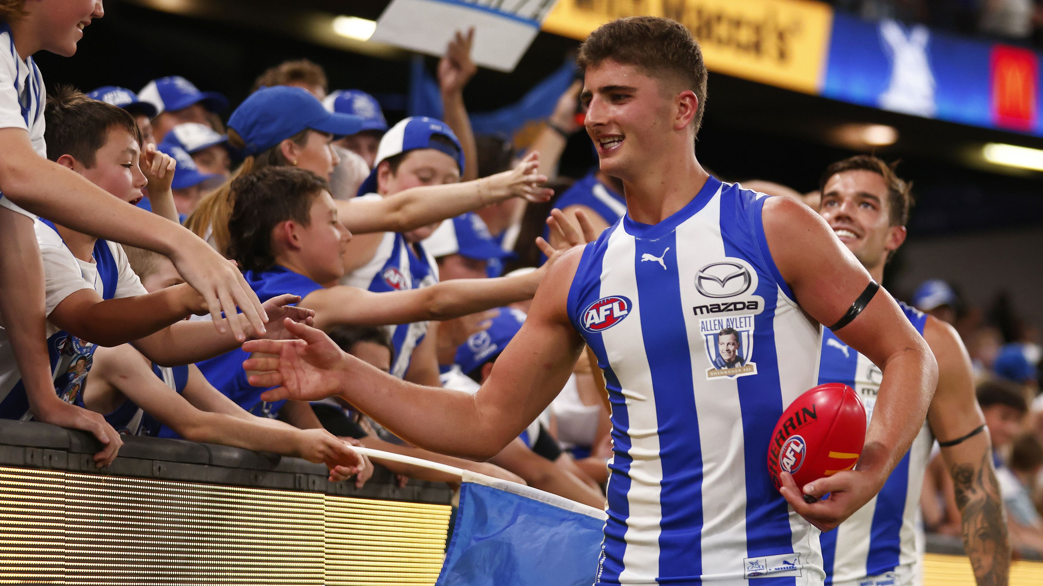 Harry Sheezel celebrates with fans after North Melbourne defeated the West Coast Eagles.