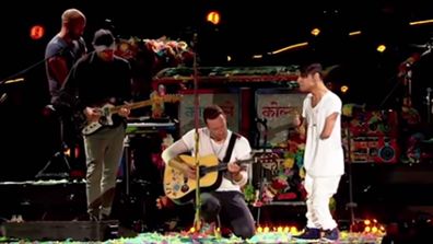 Emmanuel Kelly performs with Chris Martin at Coldplay's Melbourne concert in 2016