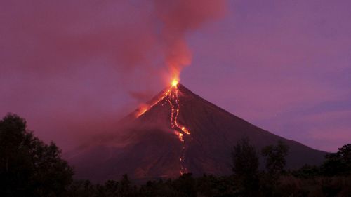 Lava flows down the slopes of Mayon volcano during its eruption in the Philippines in January