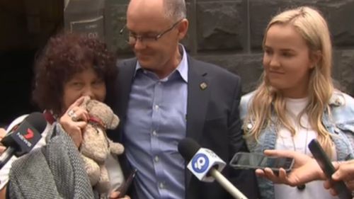 Robyn Cronin (left) holds her son's teddy bear outside the Court of Appeal in Melbourne today.