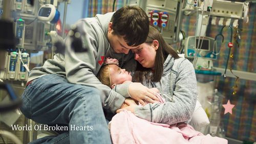 Adalyn is cradled by her parents in hospital. (World of Broken Hearts / Facebook)