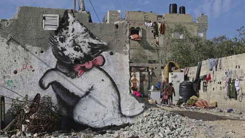 Famed graffiti artist Banksy leaves his mark in war-ravaged Gaza