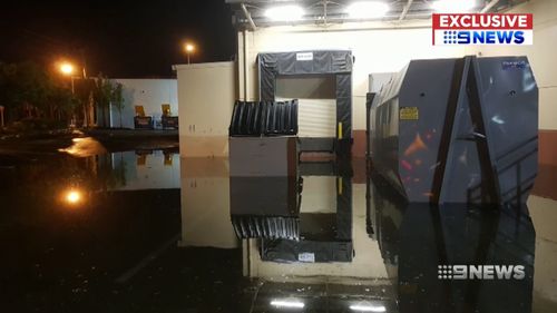 9News obtained video of flooding inside an Aldi distribution centre in which workers claim they were asked to retrieve a floating bin, despite the water reaching the same level as a cardboard compactor which had 22,000 volts running through it.