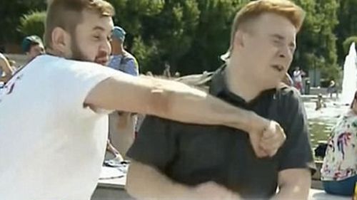A still image shows reporter Nikita Razvozzhayev  being struck during a live TV broadcast. (Supplied)