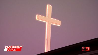 Pastor threatened with heavy fine over glowing church cross.