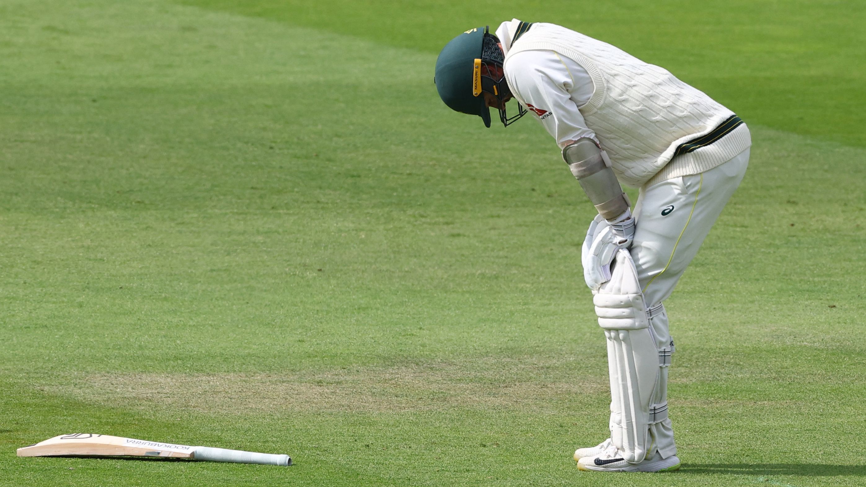 Australia&#x27;s Nathan Lyon reacts as he struggles with his calf injury.