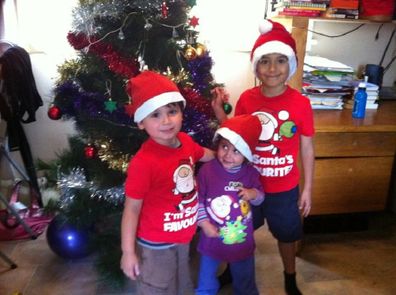 Children standing in front of a Christmas tree