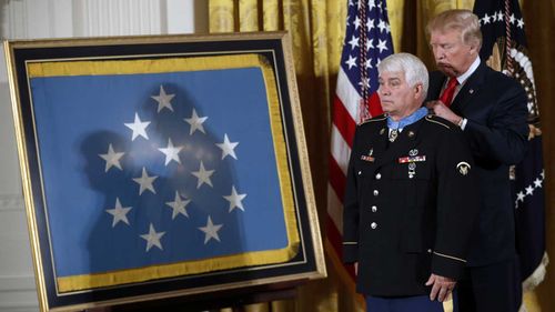 President Donald Trump bestows the nation's highest military honour, the Medal of Honour to retired Army medic James McCloughan in 2017.