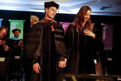 Miranda Kerr and husband Evan Spiegel surprise graduating college students by paying off all $14 million of their student loans.