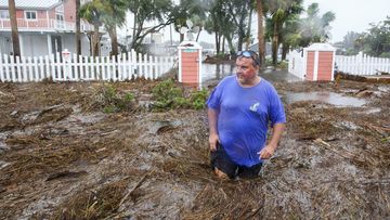 Daniel Dickert wades through water in front of his home where the Steinhatchee River overflowed on Wednesday, Aug. 30, 2023, in Steinhatchee, Fla., after the arrival of Hurricane Idalia.