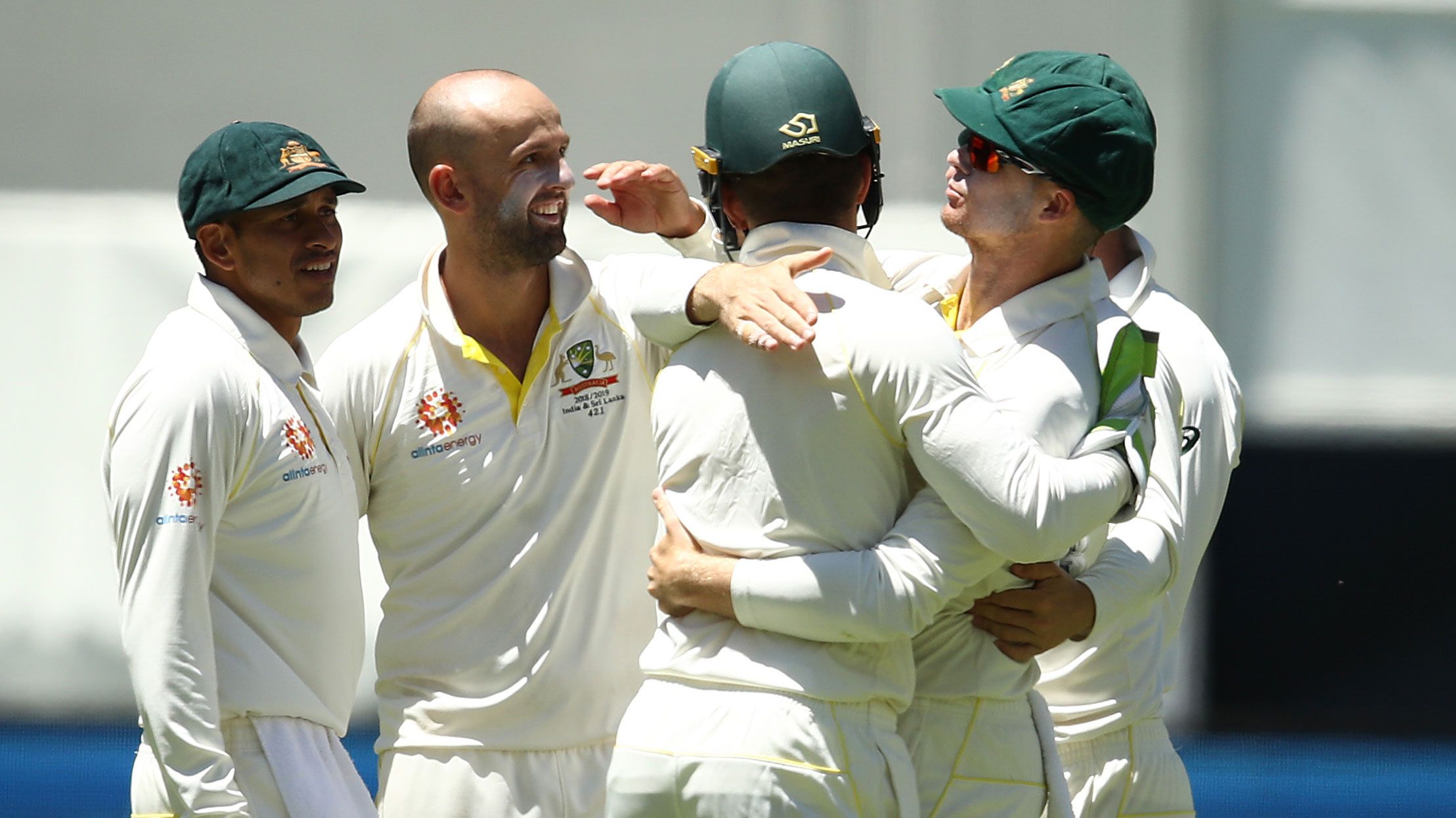 Peter Handscomb celebrates a Nathan Lyon wicket with teammates.