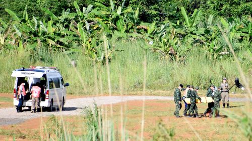 A stretcher carrying what is believed to be a fifth boy rescued from a cave in northern Thailand is carried from an ambulance. (AAP)