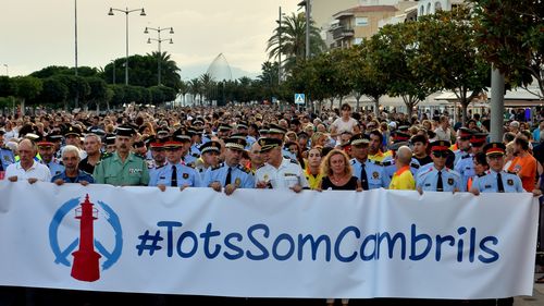 Thousands of people hold sign-boards and posters in Tarragona, Spain on August 25, 2017 to demonstrate against terrorism and the recent attacks in Barcelona. (AAP)