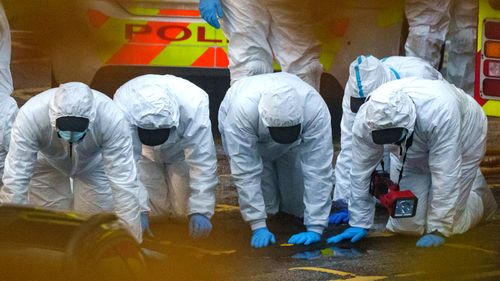 Police and forensic officers carry out a fingertip search at Liverpool Women's hospital. A man was killed when the taxi in which he was riding exploded outside the hospital.