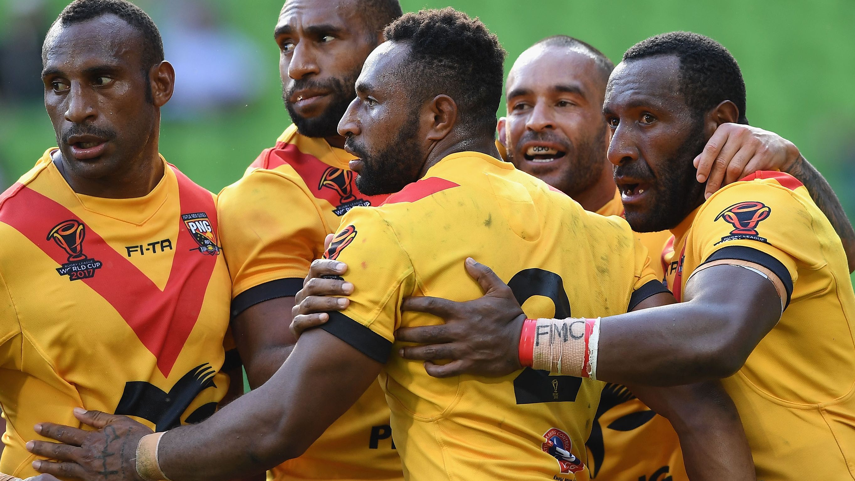 Papua New Guinea Kumuls players celebrate a try against England at the 2017 Rugby League World Cup quarter finals.