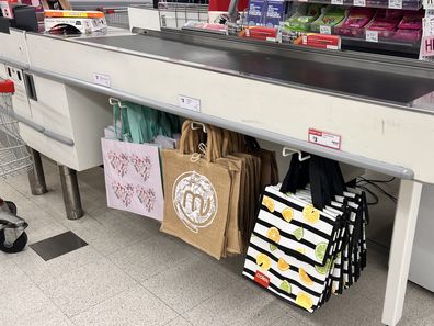 shopping bags at supermarket groceries coles woolworths aldi 